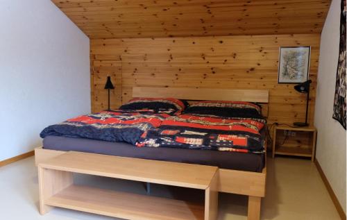 a bedroom with a bed with a wooden wall at Arca 12 in Leukerbad