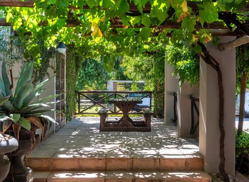 a pergola with a table and chairs on a patio at Kakamas Hotel in Kakamas