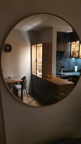 a kitchen with a table and a table and a mirror at Apartment Between in Kraków