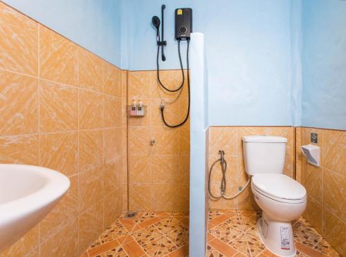 a bathroom with a toilet and a shower at Lightplus Khao Lak in Khao Lak
