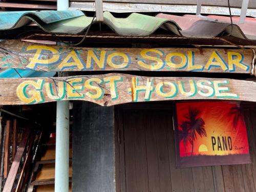 a store sign for a guest house on a building at Pano Solar Guest House (พาโน โซล่า เกสเฮ้าส์ ) in Trat