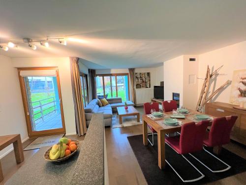 a living room with a table and a couch at Walensee Apartment, Lakeside Dream in Unterterzen