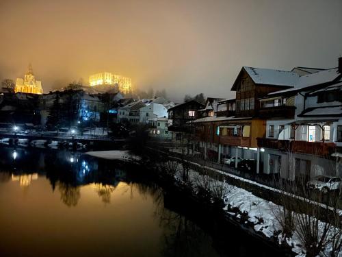 a city with buildings and a river at night at Gästehaus Biobauernhof Mandl in Murau