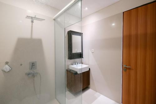 a bathroom with a sink and a glass shower at The Lavana River Villas Lombok in Senggigi