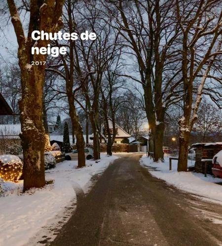a snow covered street with trees and the words climates die helpless at Landhaus de Gaspary in Seehausen am Staffelsee