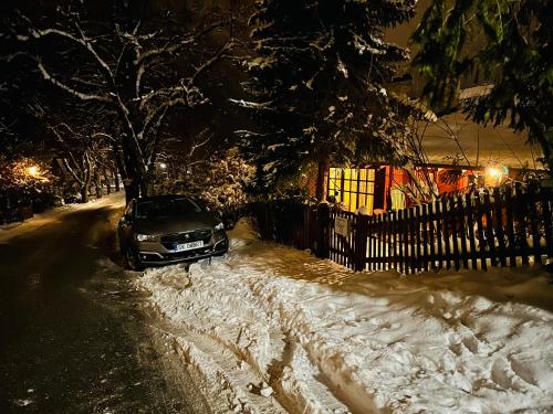a car parked on a snow covered street at night at Landhaus de Gaspary in Seehausen am Staffelsee