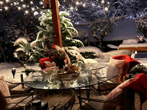 a glass table with christmas decorations on a patio at Landhaus de Gaspary in Seehausen am Staffelsee