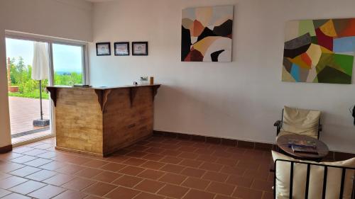 a room with a desk and some paintings on the wall at Sumeru in Sen Monorom