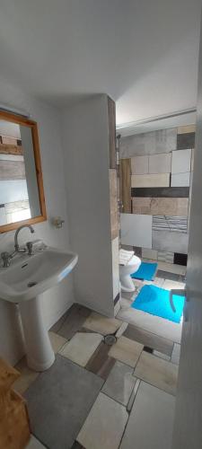 a bathroom with a sink and a mirror at "STELIOS & GALINI" in Symi