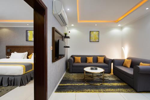 a hotel room with a bed and a couch at Mirada Purple - Al Waha in Jeddah