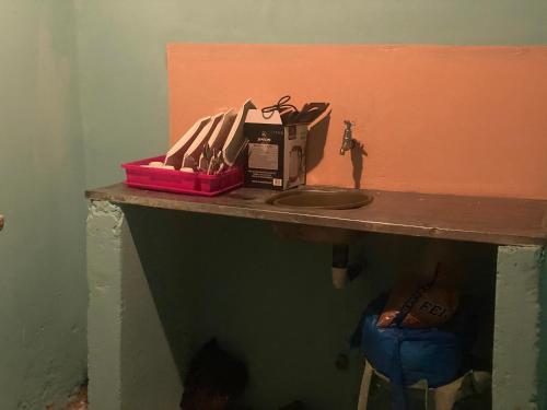 a bathroom counter with a sink and a box on it at Aeropark Residencial (B&B) in Maputo