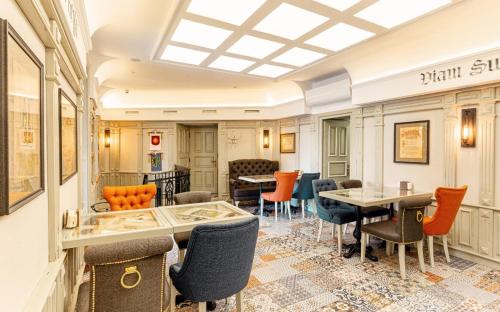 a dining room with chairs and tables and a ceiling at Hotel Natalia 18 in Lviv