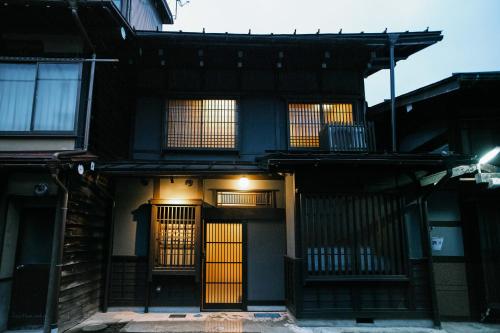 an old house with yellow doors and windows at SATOYAMA STAY Tono-machi in Furukawachō