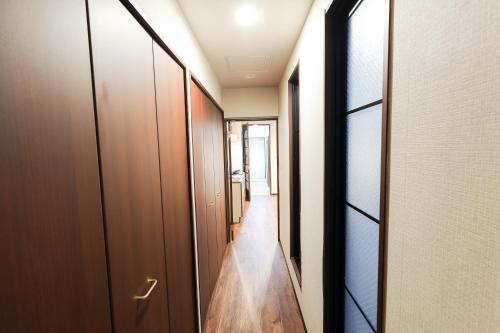 a hallway with wooden doors and a hallway with at Ocean Niponichi in Osaka