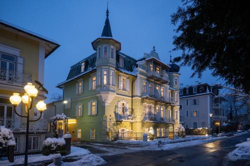 a large building with a tower on top of it at Villa Rein Boutiquehotel in Bad Reichenhall
