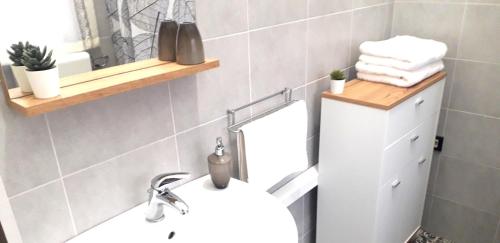 a bathroom with a white sink and a mirror at SHORT LETS Radici di Puglia in Fragagnano