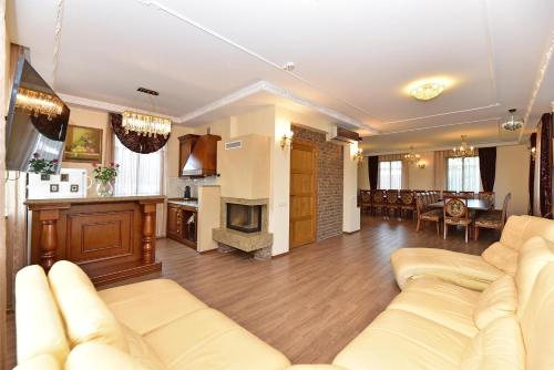 a living room with a couch and a kitchen at Spa Villa Trakai in Trakai