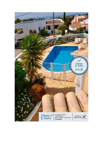 a picture of a swimming pool with a sign next to it at Casa Júlia in Carvoeiro