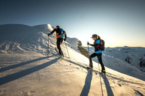 two people cross country skiing on a snow covered mountain at Landhaus Kostenzer mit Sauna in Fügen