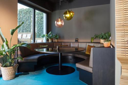 a living room with a couch and a table at Cocoon Sendlinger Tor in Munich