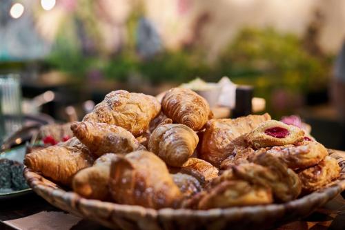a basket of pastries and croissants on a table at Cocoon Sendlinger Tor in Munich