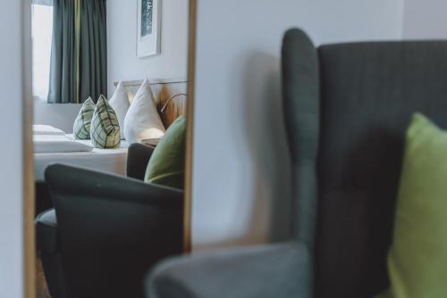 a living room with a couch and a mirror at Der Gollinger in Saalbach Hinterglemm