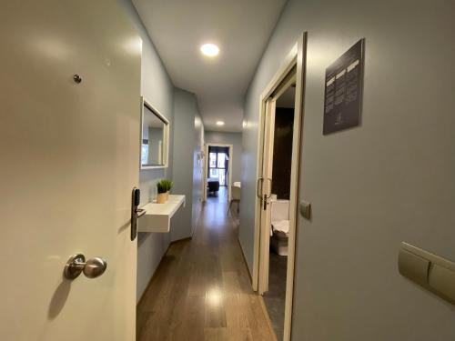 a hallway with a door leading into a room at Gros City Apartments in San Sebastián