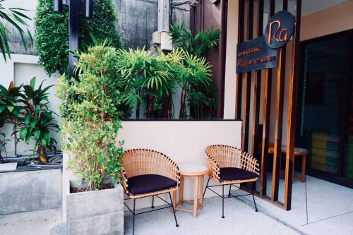 a table and two chairs sitting outside of a restaurant at Ratana Residence Thalang in Thalang