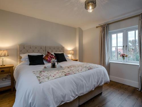 sypialnia z dużym łóżkiem i oknem w obiekcie Wisteria House w mieście Henstead