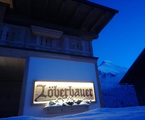 a sign on the side of a building at Landhaus Löberbauer in Tux