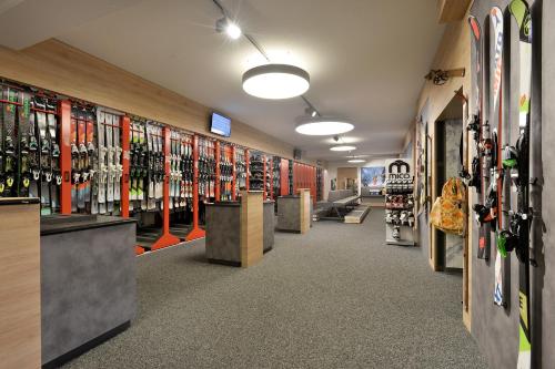 a room filled with lots of skis on display at Hotel Almhof in Hochfugen