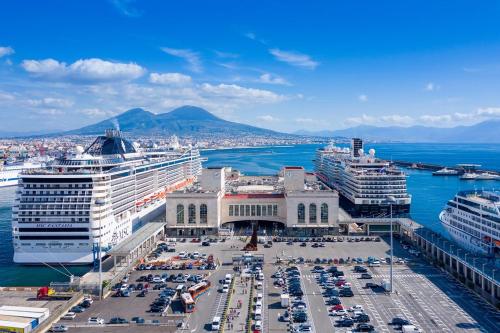 a group of cruise ships docked in a harbor at AllYouCanTrip - Porto in Naples