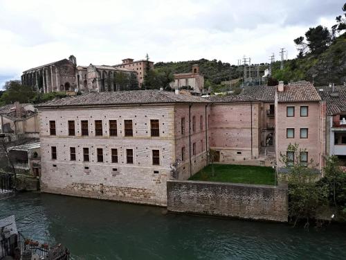 an old building on the river in a city at CASA DANIELA APARTAMENTOS-The pilgrim's house apartments in Estella