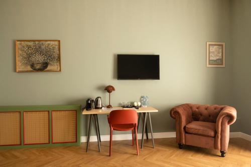 a room with a table and a chair and a desk at Margot Old Tbilisi in Tbilisi City