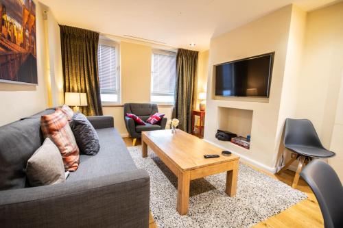 a living room with a couch and a coffee table at Tower Bridge 2BR apartment for 6 with terrace in London