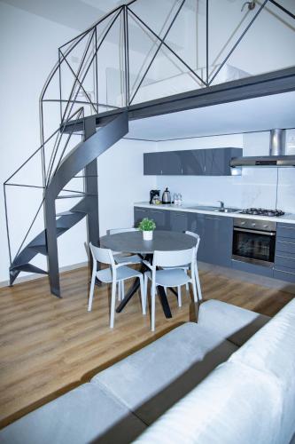 a kitchen and dining room with a table and chairs at Easy Milano - Rooms and Apartments Navigli in Milan
