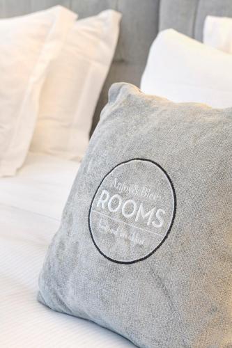 a pillow sitting on top of a bed at Anjoy&Bleev Rooms in Rho