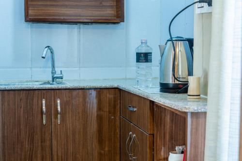 a kitchen counter with a sink and a coffee maker at Kuna Resort in Kathmandu