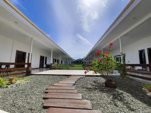 an empty courtyard of a building with a plant at San Pedro Country Farm Resort and Event Center Inc in Cantilan
