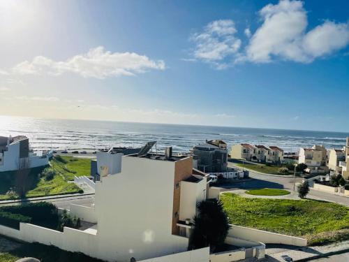 a view of the ocean from a building at Apartamento foz village in Buarcos