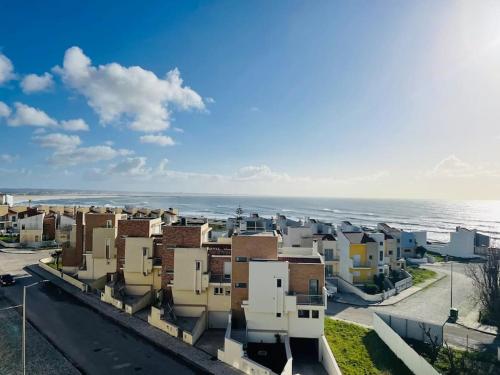 a view of a city with the ocean in the background at Apartamento foz village in Buarcos