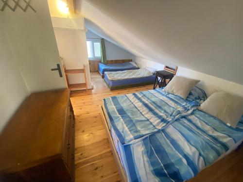 an attic bedroom with a bed and a couch at Blue Abyss Apartment in Susak