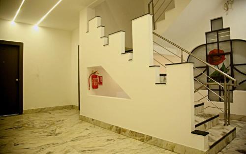a staircase in a white room with a person on the wall at Hotel Nisha Nest, Bhopal in Bhopal