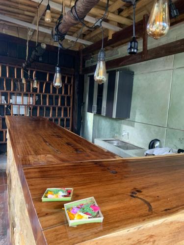 a kitchen with a wooden counter with three plates on it at Kayu81- Beautiful Pool Vila Ubud Mountain View 2BR in Bedahulu