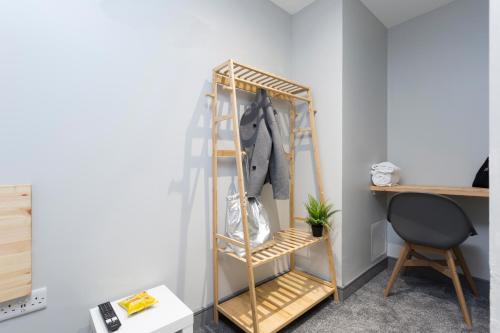 a wooden shelf in a room with a desk and a chair at Bank Square Town House in Belfast