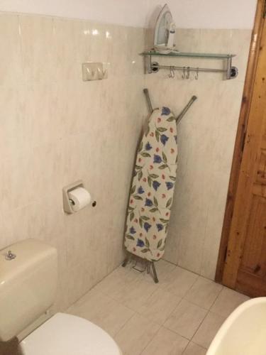 a bathroom with a surfboard hanging on the wall at ARISTIDIS Apartments in Lefkimmi