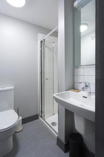 a bathroom with a sink and a shower and a toilet at Bank Square Town House in Belfast