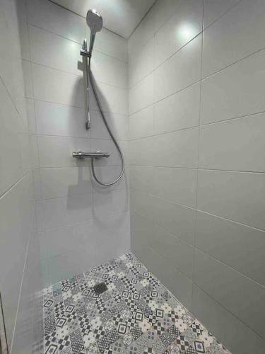 La salle de bains est pourvue d'une douche et de carrelage. dans l'établissement Appartement neuf tout confort à Blaye proche de la Citadelle, à Blaye