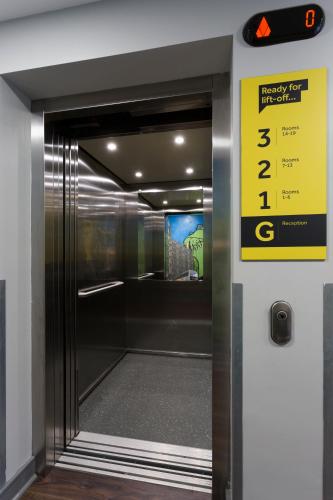 an elevator door with a sign on it at Bank Square Town House in Belfast