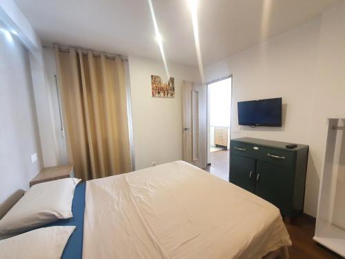 a bedroom with a bed and a television in it at Piso familiar Salou in Salou